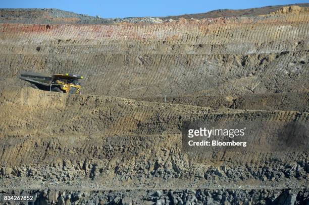 Dump trucks drives down an access ramp to the White Foil open mine pit at Evolution Mining Ltd.'s gold operations in Mungari, Australia, on Tuesday,...