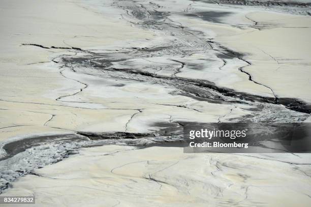 Hardened waste forms cracks and patterns on the surface of the tailings dam at Evolution Mining Ltd.'s gold operations in Mungari, Australia, on...