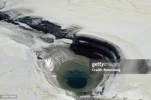 Small pool of water forms around a pipe inlet on the tailings dam at Evolution Mining Ltd.'s gold operations in Mungari, Australia, on Tuesday, Aug....