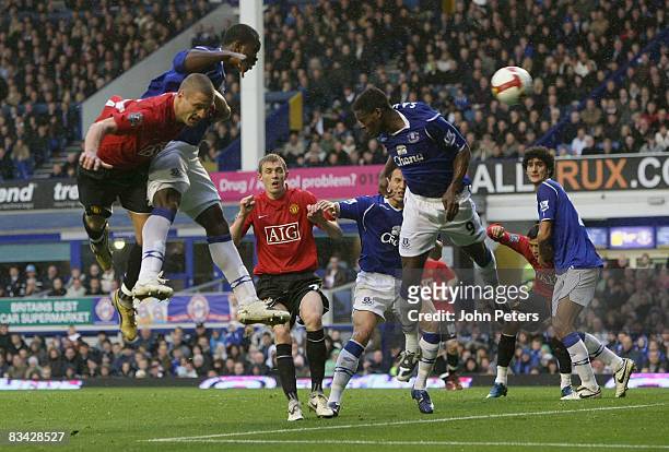 Nemanja Vidic of Manchester United heads towards goal with Joseph Yobo of Everton challenging during the Barclays Premier League match between...