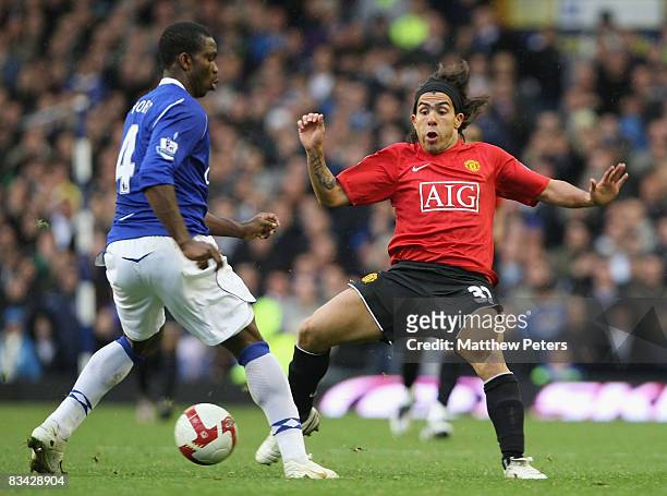 Carlos Tevez of Manchester United clashes with Joseph Yobo of Everton during the Barclays Premier League match between Everton and Manchester United...