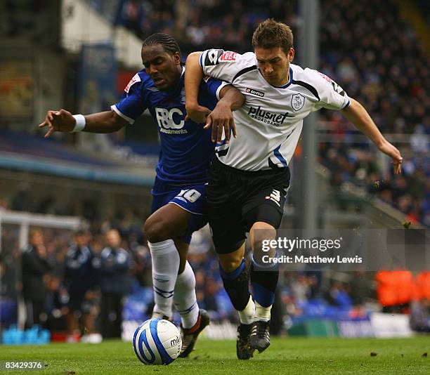 Cameron Jerome of Birmingham and Peter Gilbert of Sheffield challenge for the ball during the Coca-Cola Championship match between Birmingham City...