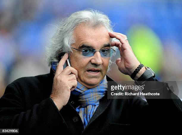 Owner Flavio Briatore talks on the phone as the players warm up before the Coca-Cola Championship match between Reading and Queens Park Rangers at...