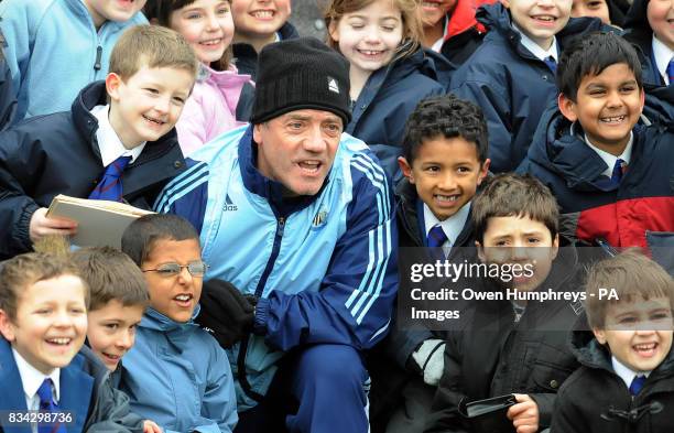 Newcastle United manager Kevin Keegan poses for a photograph with children from the Royal Grammar School , Newcastle during a training session at...