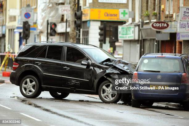 The scene in Bethnal Green Road, east London, after a black Mercedes four-wheel drive jeep being pursued by a police car crashed into several cars...