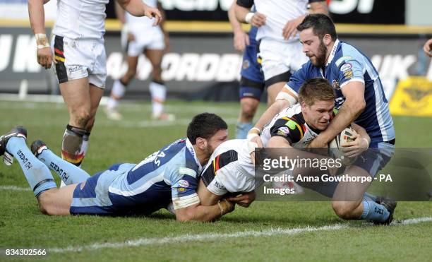 Bradford Bulls' Wayne Godwin goes over to score under pressure from Castleford Tigers' Michael Korkidas and Craig Huby during the engage Super League...