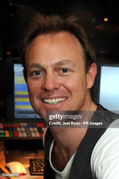 Jason Donovan poses during a photocall at the Capital FM studios in Leicester Square, central London, as he launches his new radio show 'Sunday Night...