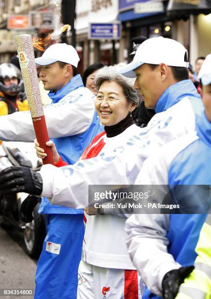 China's Ambassador to the United Kingdom Fu Ying carries the Olympic Torch during the Beijing Olympics torch relay in London