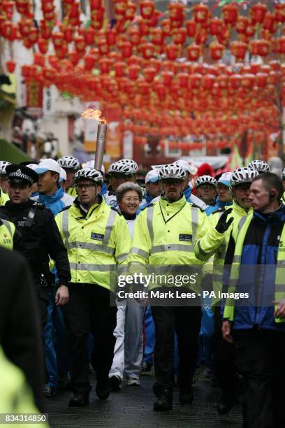China's Ambassador to the United Kingdom Fu Ying carries the Olympic torch through London's Chinatown during part of its journey across London on its...