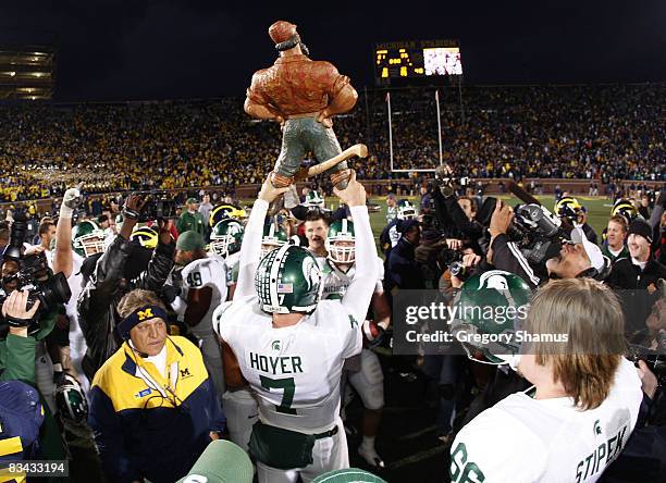 Brian Hoyer of the Michigan State Spartans holds up the Paul Bunyan trophy after beating the Michigan Wolverines 35-21 on October 25, 2008 at...