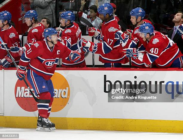 Saku Koivu of the Montreal Canadiens celebrates his first period goal against the Anaheim Ducks with team mates at the bench at the Bell Centre on...