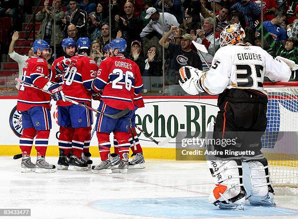 Members of the Montreal Canadiens celebrate a second period goal against Jean-Sebastien Giguere of the Anaheim Ducks at the Bell Centre on October...