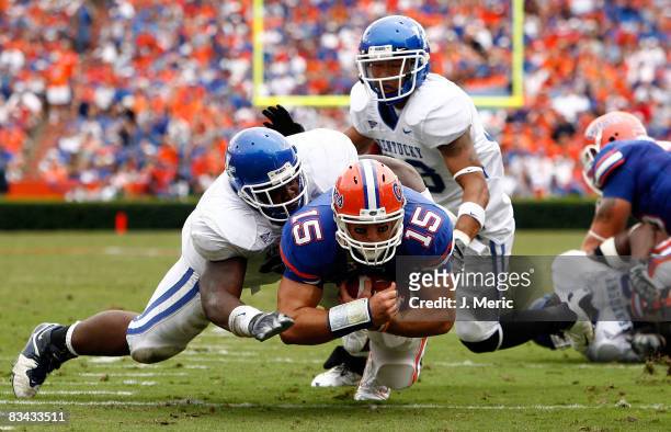 Quarterback Tim Tebow of the Florida Gators is tackled by linebacker Sam Maxwell of the Kentucky Wildcats during the game at Ben Hill Griffin Stadium...