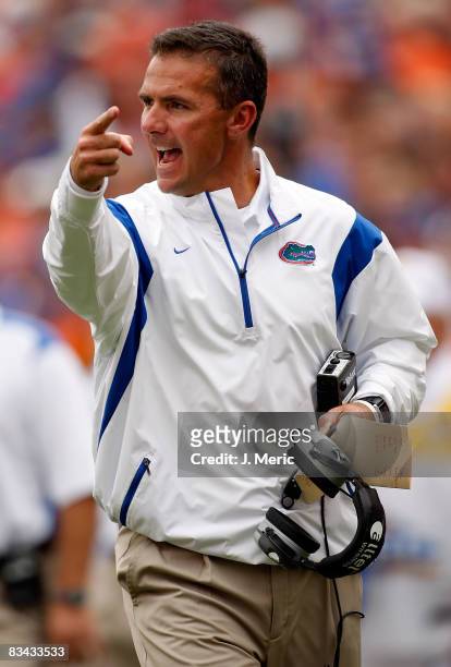 Head coach Urban Meyer of the Florida Gators calls for a first down against the Kentucky Wildcats during the game at Ben Hill Griffin Stadium at...