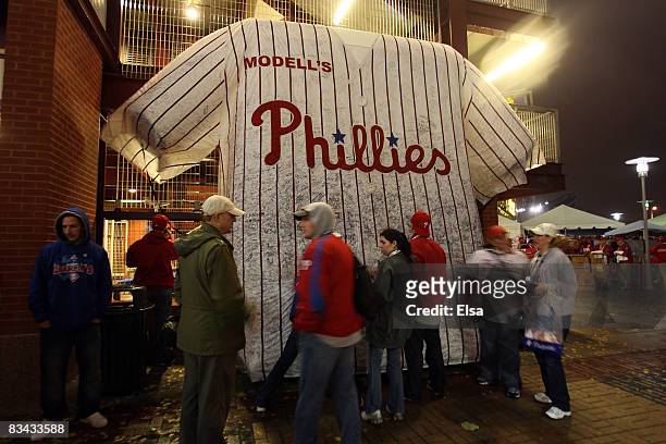 Fans sign their names and messages on a giant replica of a Philadelphia Phillies jersey prior to game three of the 2008 MLB World Series against the...