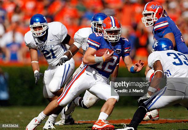 Quarterback John Brantley of the Florida Gators runs the ball as safety Calvin Harrison of the Kentucky Wildcats closes in for the tackle during the...
