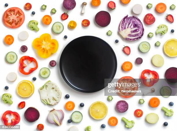 various sliced fruits and vegetables on white background. - poivron photos et images de collection