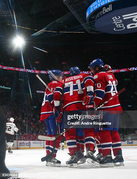 Alex Tanguay, Patrice Brisebois and Robert Lang of the Montreal Canadiens celebrate a third period goal against the Anaheim Ducks at the Bell Centre...