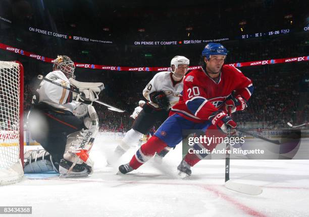 Robert Lang of the Montreal Canadiens skates against Jean-Sebastien Giguere and Kent Huskins of the Anaheim Ducks at the Bell Centre on October 25,...