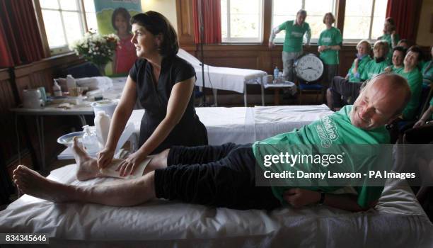 Beauty therapist Susanne Baird waxing the legs of comic Fred MacAulay during her world record leg waxing attempt in Edinburgh.