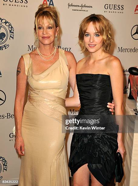 Actress Melanie Griffith and daughter Dakota Johnson pose during the cocktail reception at the 30th anniversary Carousel of Hope Ball to benefit the...