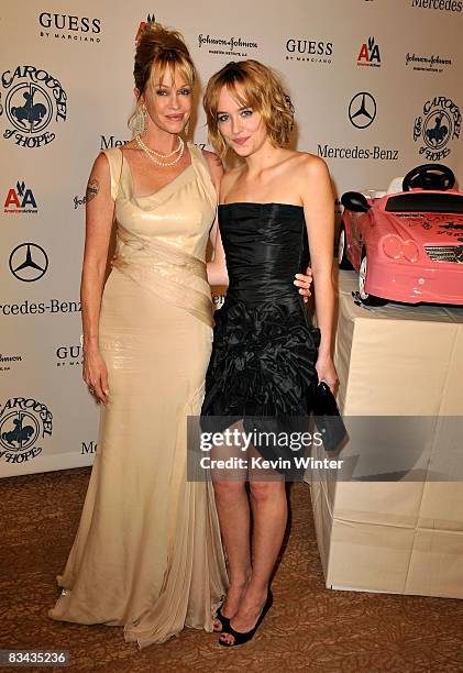 Actress Melanie Griffith and daughter Dakota Johnson pose during the cocktail reception at the 30th anniversary Carousel of Hope Ball to benefit the...