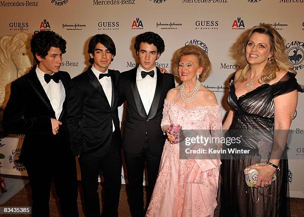 Musicians Nick Jonas, Joe Jonas, Kevin Jonas of The Jonas Brothers, Barbara Davis and Nancy Davis pose during the cocktail reception at the 30th...