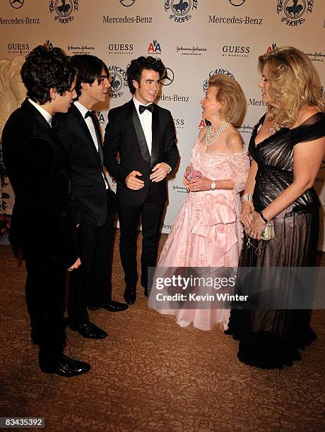 Musicians Nick Jonas, Joe Jonas, Kevin Jonas of The Jonas Brothers, Barbara Davis and Nancy Davis pose during the cocktail reception at the 30th...