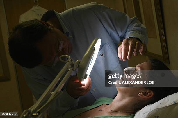 Sibongile Khumalo South African Doctor Rick examines the nose of a British patient who had plastic surgery Johannesburg on October 26, 2008. Forget...