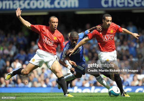 Manchester United's Mikael Silvestre and Rio Ferdinand battle for the ball with Chelsea's Salomon Kalou