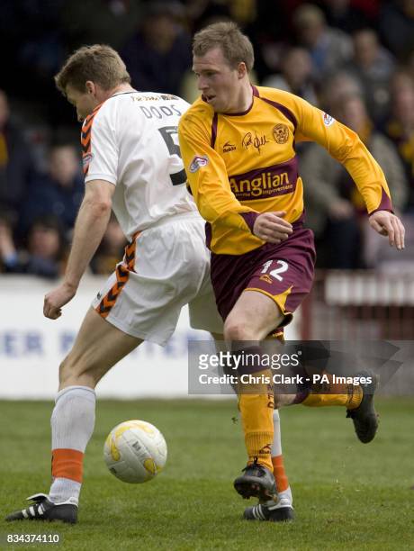 Motherwell's David Clarkson is tackled by Dundee Utd's Darren Dods during the Clydesdale Bank Scottish Premier League match at Fir Park, Motherwell.