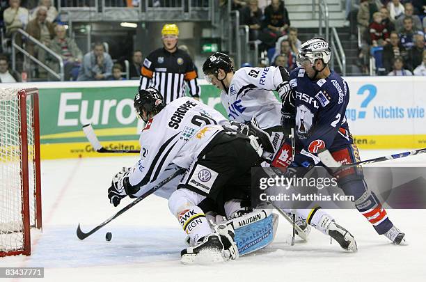 Benedikt Schopper, Patrick Hager and Deron Quint battle for the puck during the DEL Bundesliga match between EHC Eisbaeren Berlin and Krefeld...