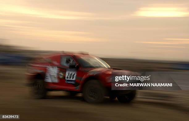 British driver Andrew Bowler and is co-driver Simon Mumby steer their Bowler Nemesis during preliminary super stage action in Dubai on October, 26...