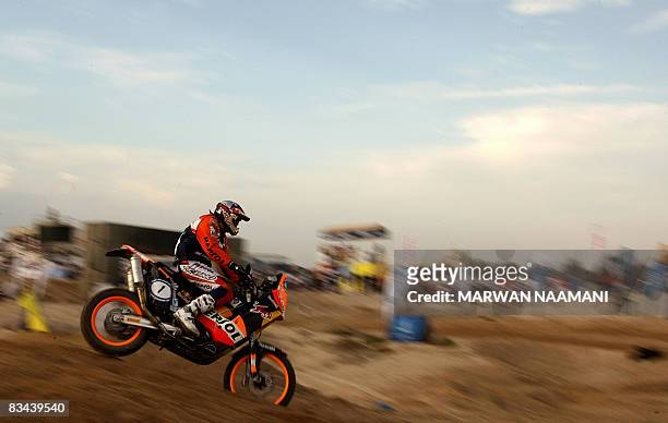 Spanish motorcyclist Marc Coma drives his 690 cc KTM Rally Replica bike during preliminary super stage action in Dubai on October, 26 2008, one day...