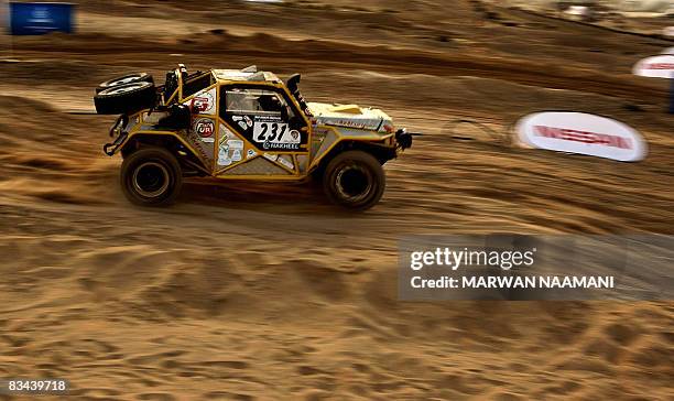 Driver Emil Khneisser and his co-driver of United Arab Emirate Rally Team steer their Ford F150 Buggy during preliminary super stage action in Dubai...