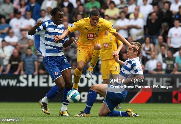 Tottenham Hotspur's Jermaine Jenas battles for the ball, with Reading's Kevin Doyle and Andre Bikey.