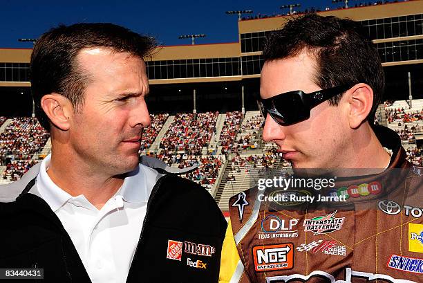 Team owner JD Gibbs speaks with his driver Kyle Busch, driver of the M&M's Toyota on the starting grid prior to the start of the NASCAR Sprint Cup...