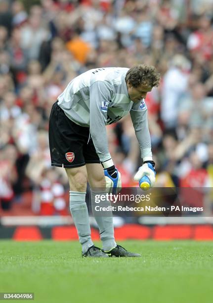Arsenal goalkeeper Jens Lehmann takes a bow as he says goodbye to the Arsenal fans after his last match at the Emirates Stadium