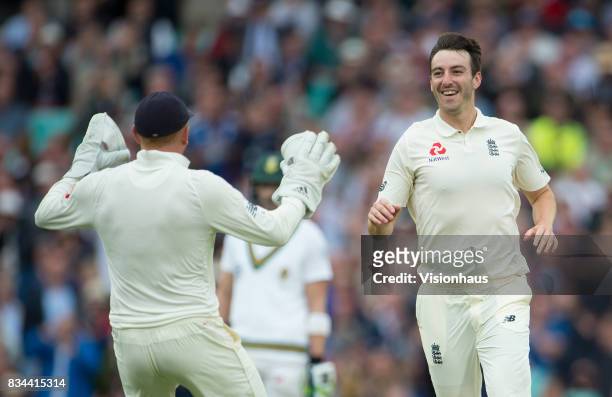 Toby Roland-Jones of England celebrates taking the wicket of Quinton de Kock of South Africa during day two of the 3rd Investec test between England...
