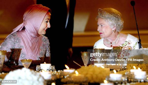 Britain's Queen Elizabeth II speaks to President Abdullah Gul's wife Hayrunnisa Gul before a State Banquet in her honour at the Presidential Palace...