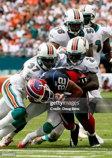 Wide receiver Josh Reed of the Buffalo Bills is brought down by Yeremiah Bell, Renaldo Hill and Charlie Anderson of the Miami Dolphins at Dolphin...