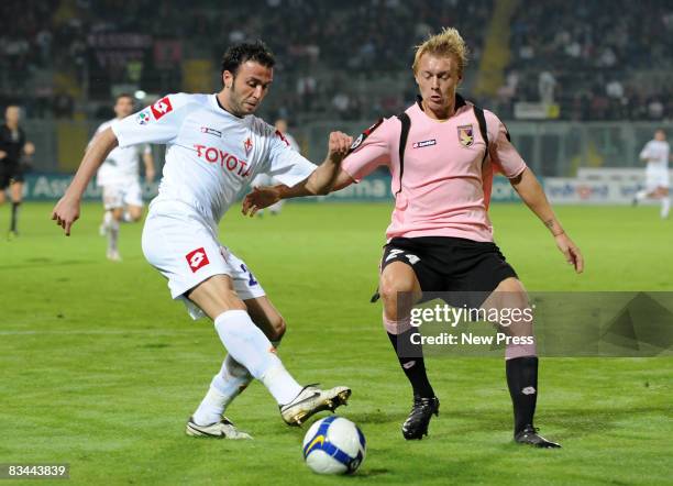 Simon Kjaer of Palermo and Giampaolo Pazzini of Fiorentina in action during the Serie A match between Palermo and Fiorentina at the Stadio Barbera on...
