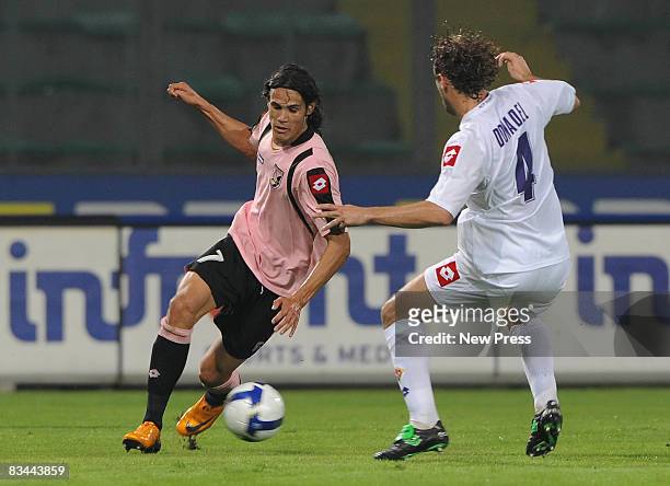 Edinson Cavini of Palermo and Marco Donadel of Fiorentina in action during the Serie A match between Palermo and Fiorentina at the Stadio Barbera on...