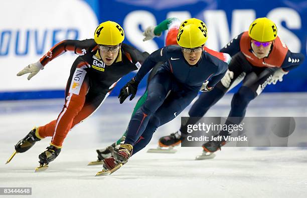 Celski of the United States skates to a first place finish during his 1000m quarterfinal heat in front of Michael Gilday of Canada and Sjinkie Knegt...