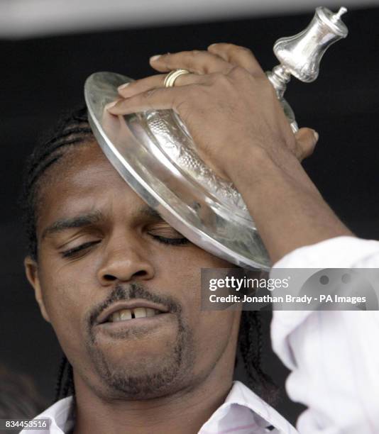 Winning Portsmouth goalscorer Nwankwo Kanu dances with FA Cup onstage during a parade in Portsmouth.