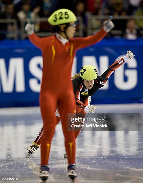 Marianne St-Gelais of Canada smiles during her second place finish as Meng Wang of China finishes first in the ladies 500m final at the ISU World Cup...