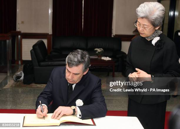 Prime Minister Gordon Brown with Chinese ambassador Fu Ying, signing the book of condolences at the Chinese Embassy in London, to pay respects to...