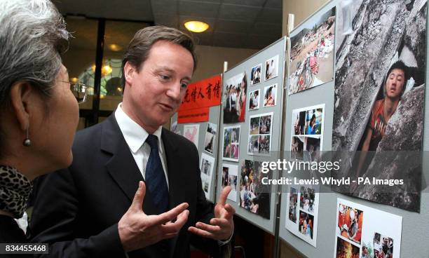 Conservative leader David Cameron with Chinese ambassador Fu Ying, looking at pictures of devastation caused by the Sichuan earthquake at the Chinese...