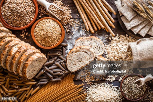 wholegrain food still life shot on rustic wooden table - wholegrain pasta stock pictures, royalty-free photos & images