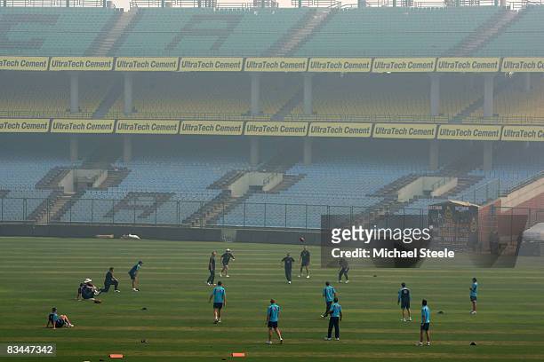 The Australia team warm up as early morning smog surrounds the Australian cricket team nets session at the Ferozeshah Kotla Stadium on October 27,...